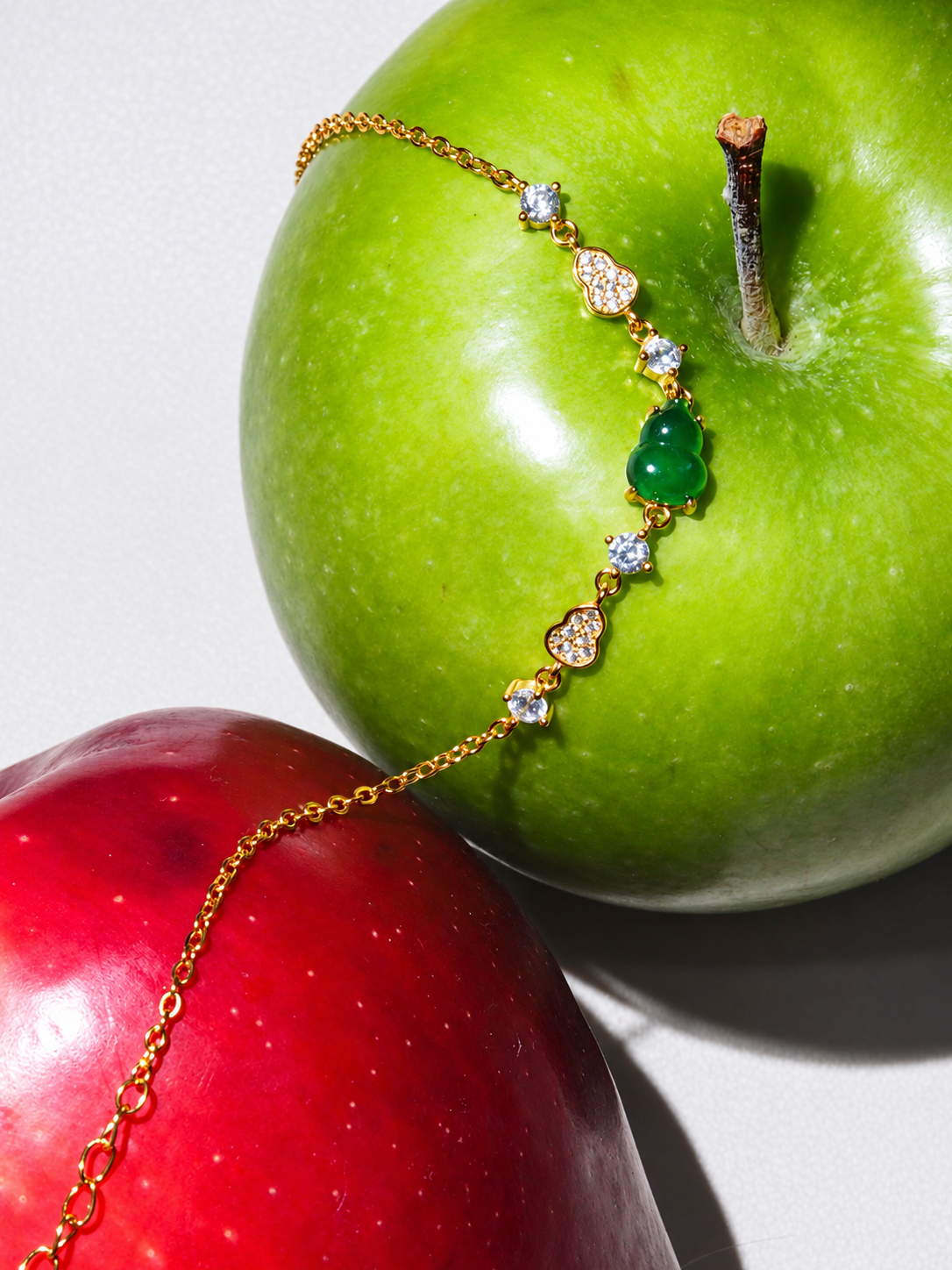 Green jadeite Hulu charm bracelet with gold-tone chain, detail view