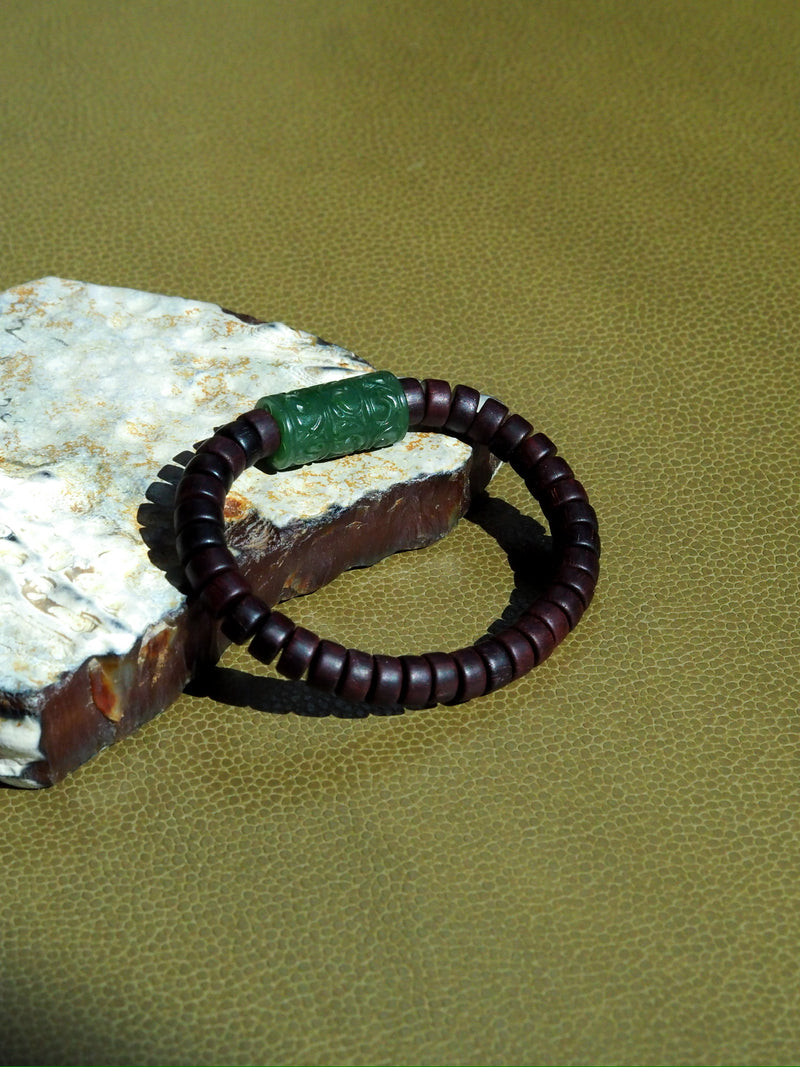 Green jade, warm. Sandalwood, still. One bracelet, two wishes: may every path open, may every day be safe.