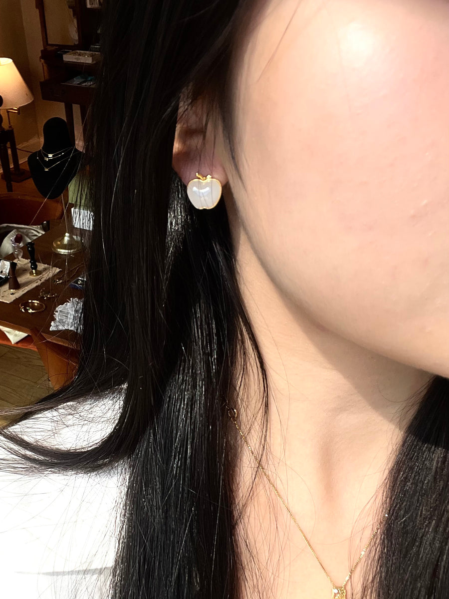 Close-up of white jade apple-shaped stud earrings