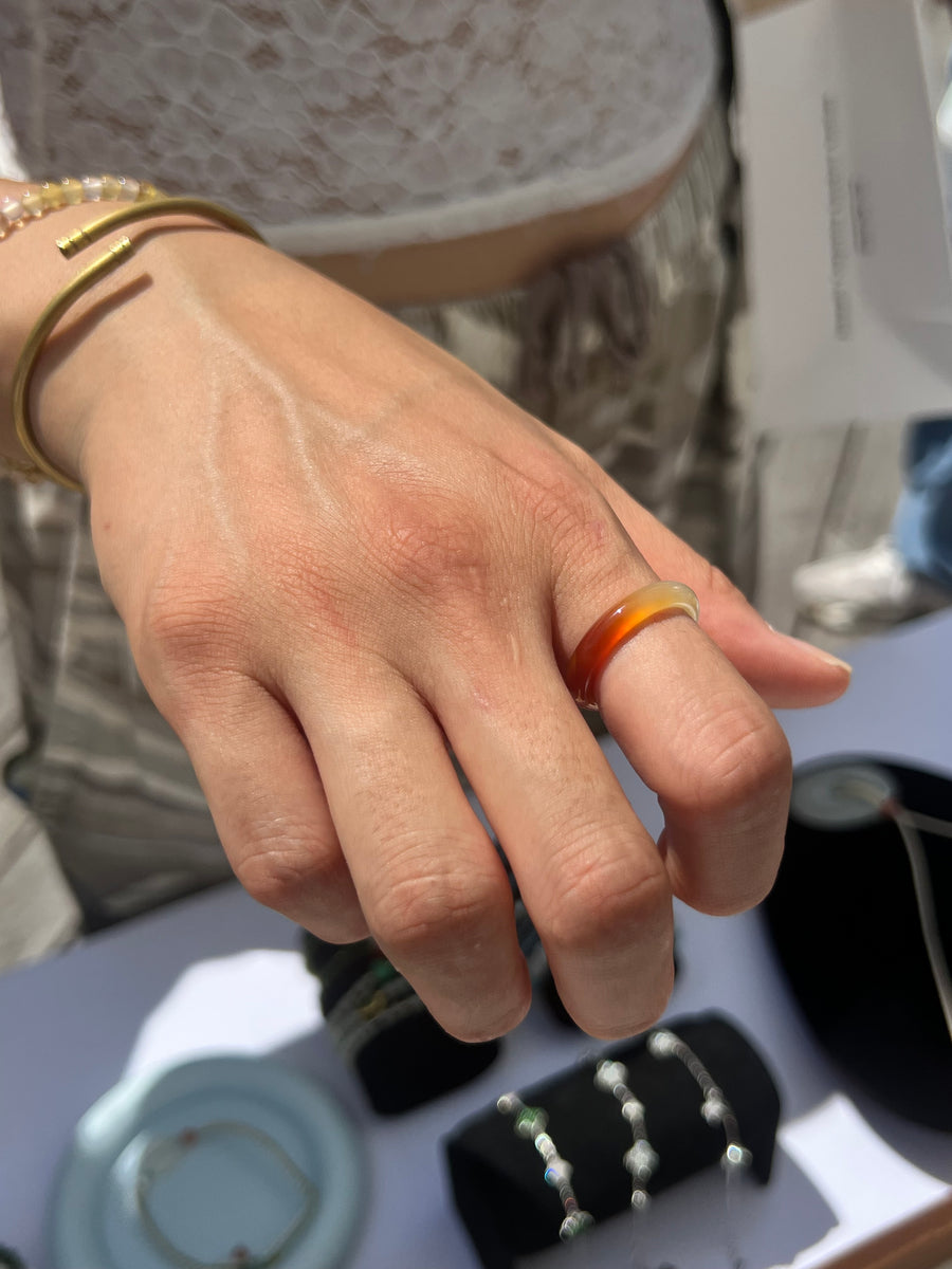 Customer wearing a warm orange dawnlight agate ring