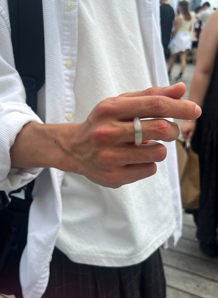 Customer wearing a pale green quartzite jade ring with a white shirt